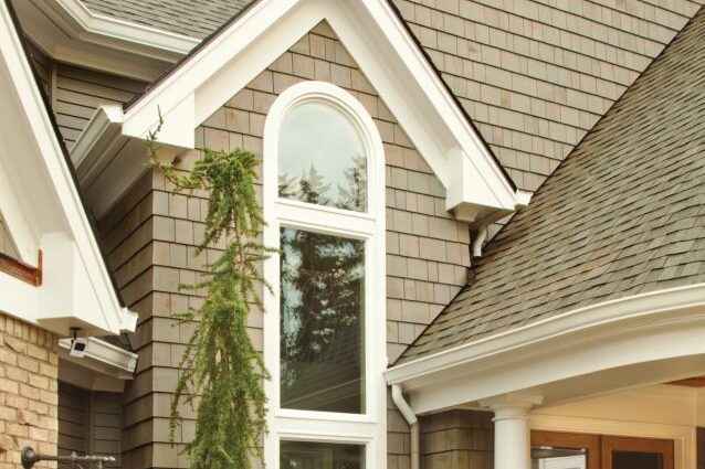 Arched-top specialty shape window on a home exterior